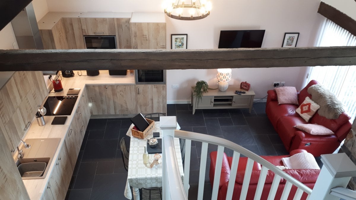 Carrog Farm Cottages - Y Gorlan, looking down on the living area from the mezzanine